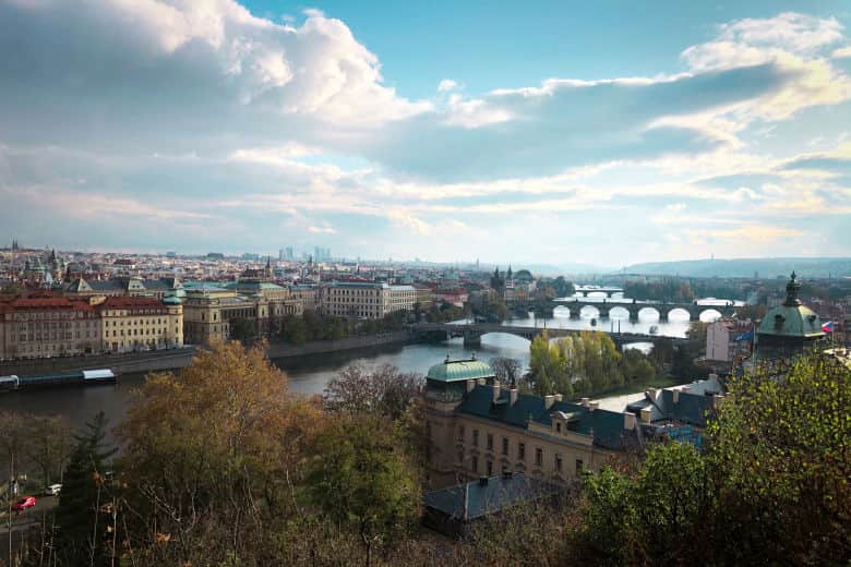 a great photography spot in prague from letna park overlooking the city and prague's many bridges