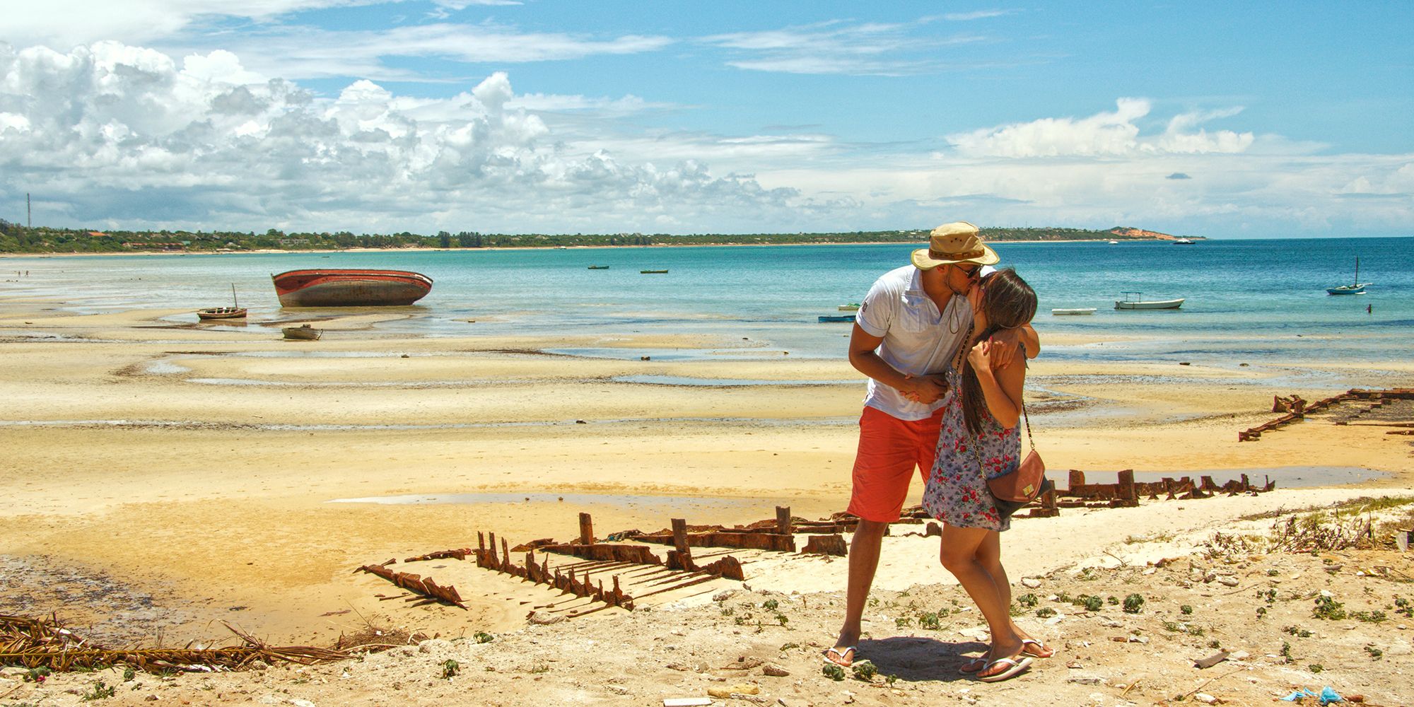 a travel blogger couple kissing on a beach located in the bay of Vilankulos in Mozambique